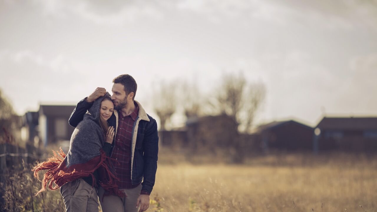 Couple smiling together at home in garden.